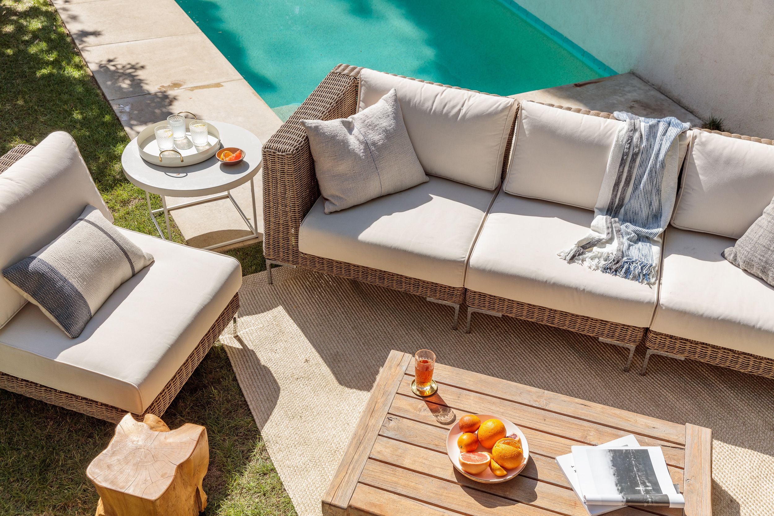 The durable and sustainable outdoor brown wicker sofa with attractive cream color cushions.