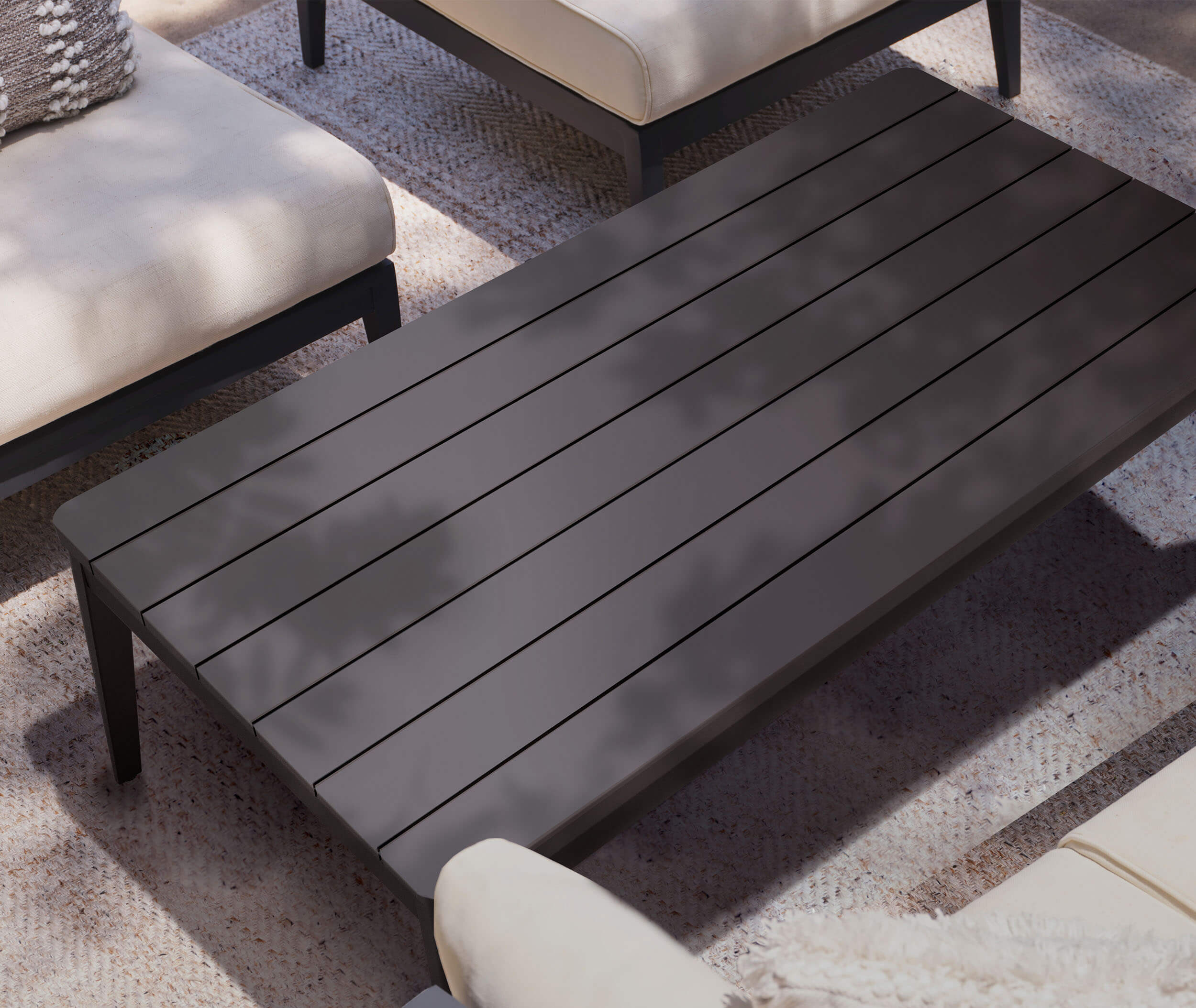 Outdoor coffee table placed between seating