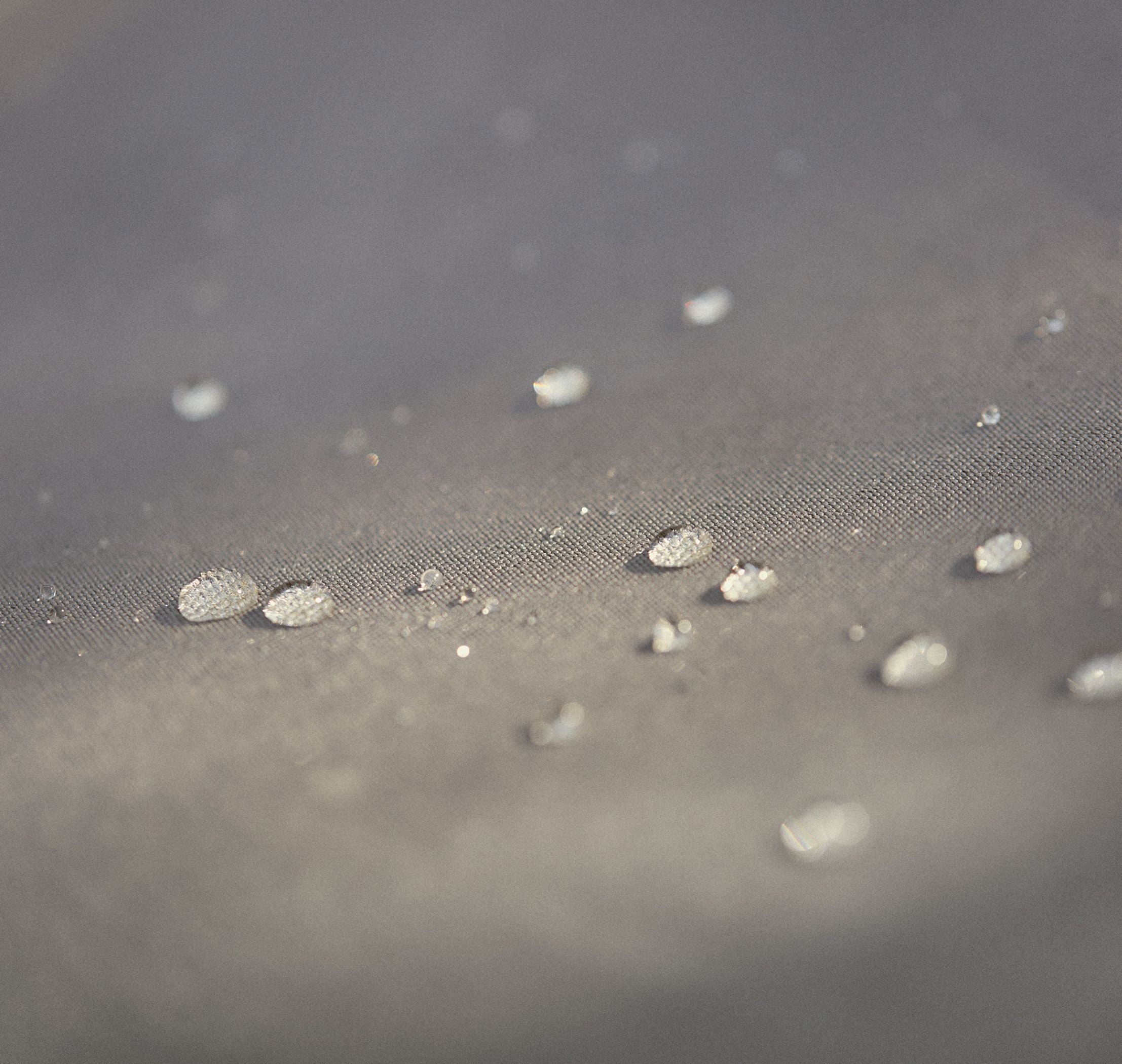 Water droplets beading on outdoor fabric, highlighting Outer’s innovative performance materials
