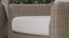 Outer Outdoor Sofa with OuterWeave™ cushion demonstrating spill resistance, as a beverage is poured onto the cushion and rinsed clean with water.