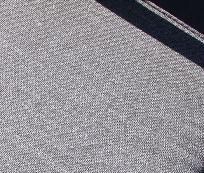 Close-up of gray outdoor dining chair cushion fabric, showing woven upholstery texture detail