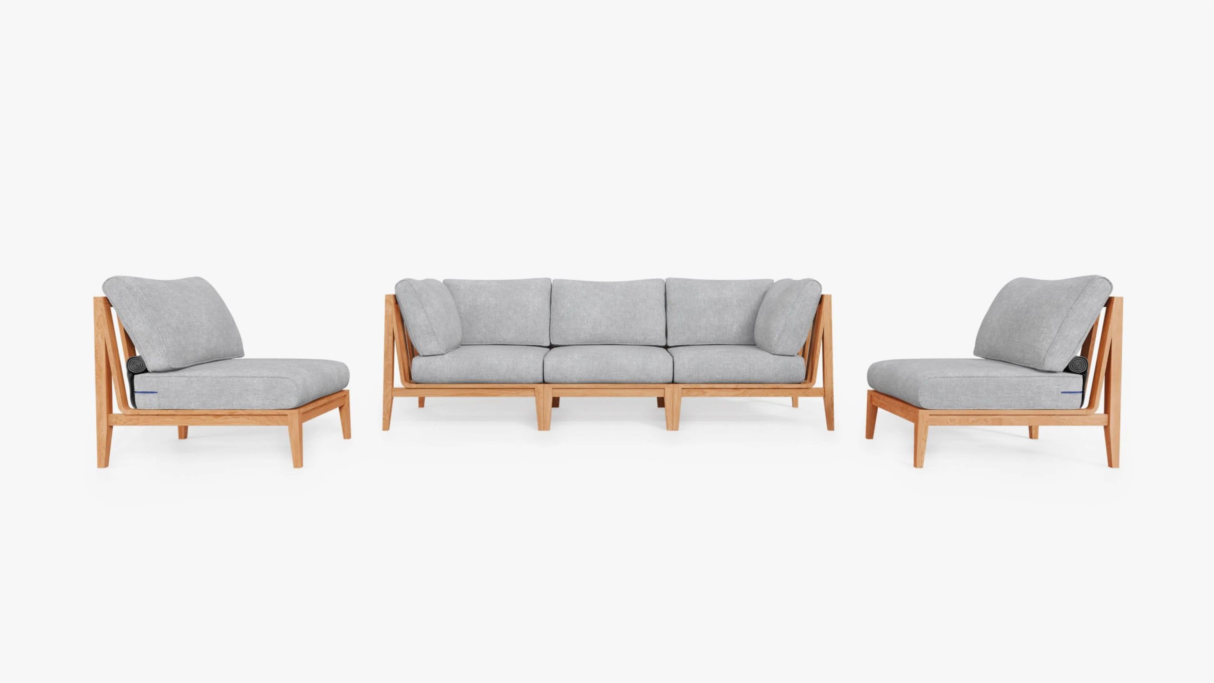 Outdoor teak sectional sofa set with gray cushions, including a three-seat sofa and two lounge chairs, on a white background