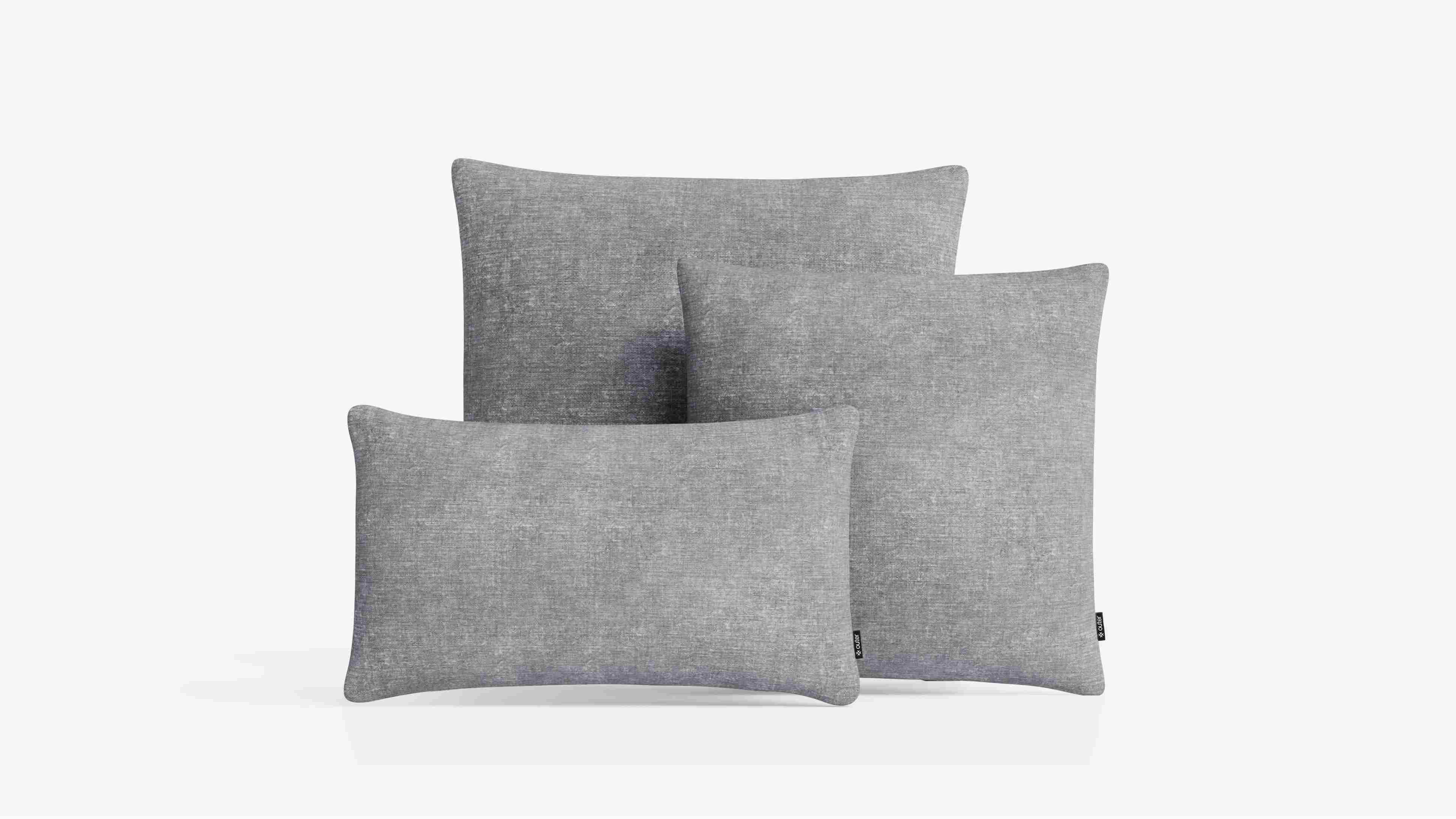 Set of gray outdoor throw pillows in different sizes on a white background