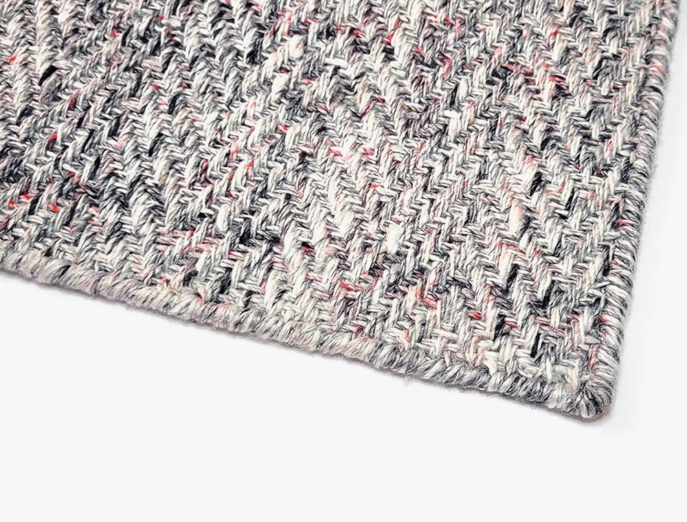 Eco-Friendly Outdoor Rug in Seashell Gray, corner closeup. Durable and sustainable outdoor rug made from recycled plastic bottles. #color_Seashell Gray