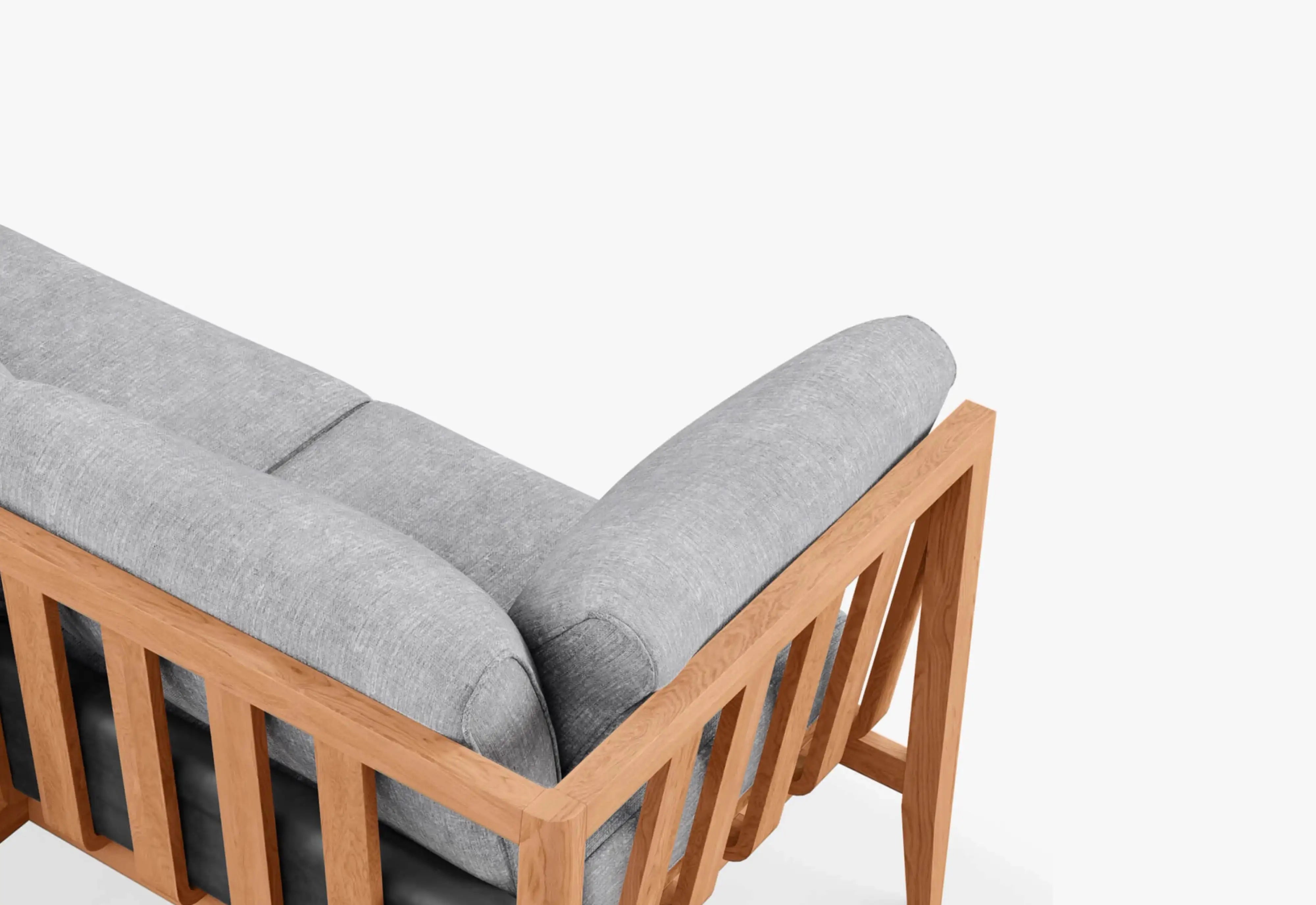Close-up of Outer wicker outdoor sofa showing armrest and cushion on a white background
